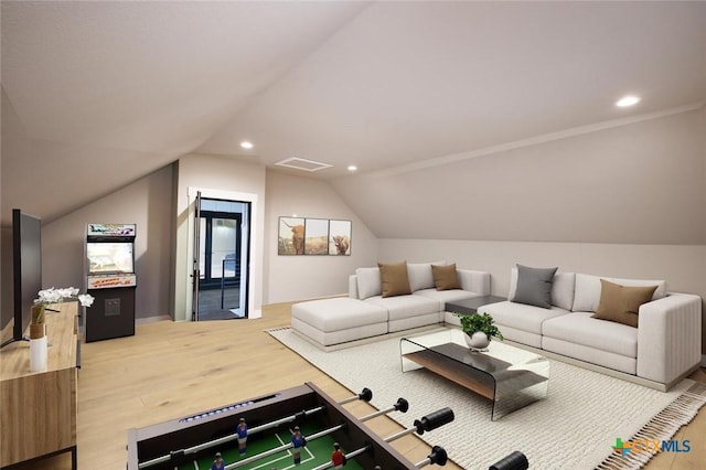 living room featuring vaulted ceiling and hardwood / wood-style floors