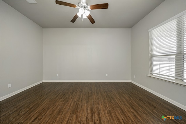 empty room with dark hardwood / wood-style flooring and ceiling fan