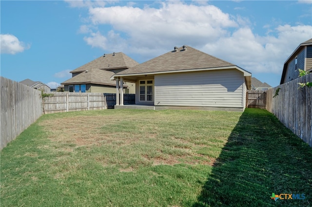 back of property with a patio and a yard