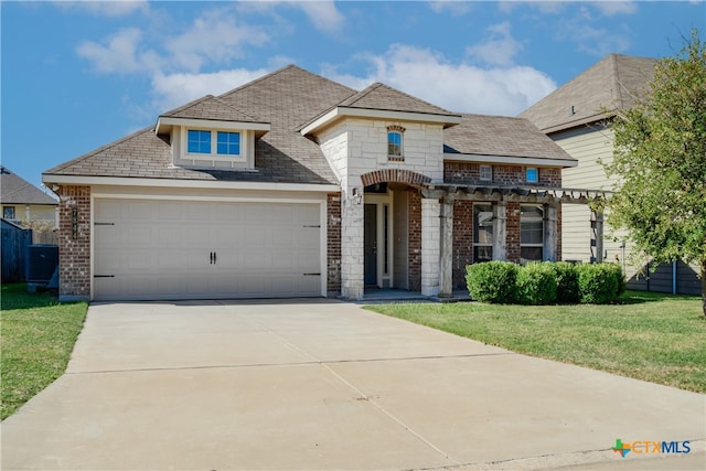 view of front of house featuring a garage and a front yard