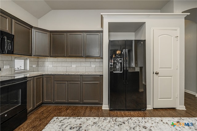 kitchen with dark brown cabinets, black appliances, lofted ceiling, and tasteful backsplash