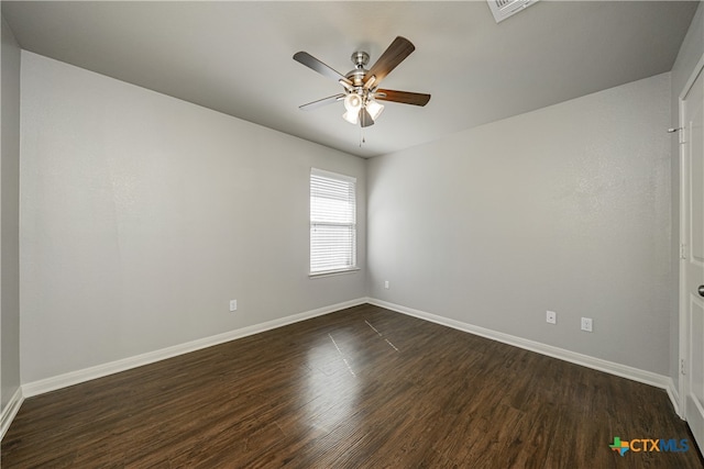 spare room featuring dark hardwood / wood-style flooring and ceiling fan