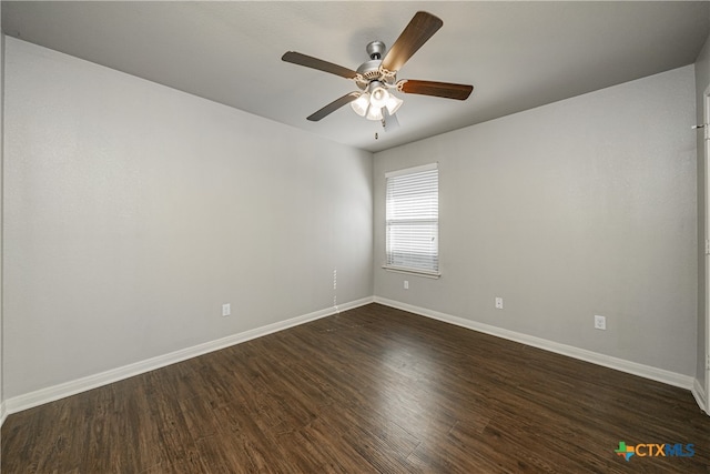 spare room with dark wood-type flooring and ceiling fan