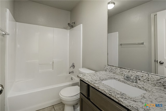 full bathroom featuring washtub / shower combination, tile patterned flooring, toilet, and vanity