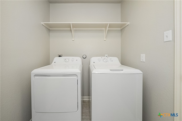 clothes washing area with washer and clothes dryer