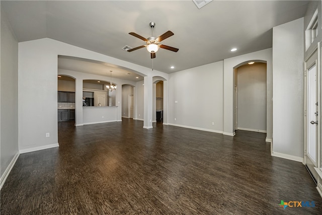 unfurnished living room with dark hardwood / wood-style flooring, lofted ceiling, and ceiling fan with notable chandelier