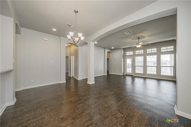 unfurnished living room featuring ceiling fan with notable chandelier and dark hardwood / wood-style floors