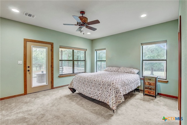 carpeted bedroom with ceiling fan, multiple windows, and access to outside