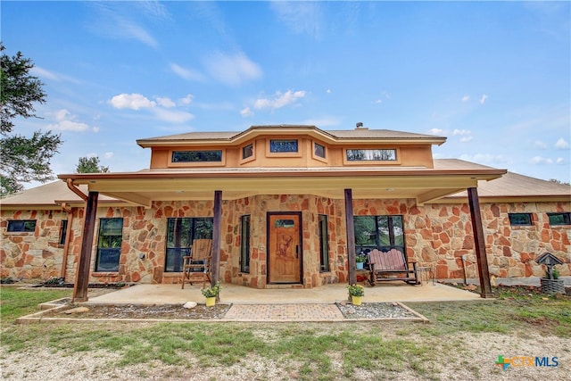 rear view of property featuring a porch