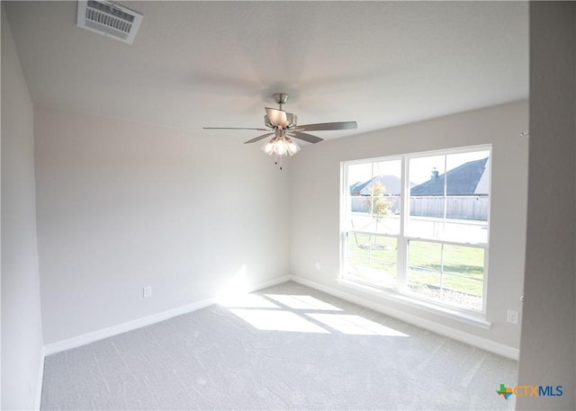 unfurnished room featuring light carpet and ceiling fan