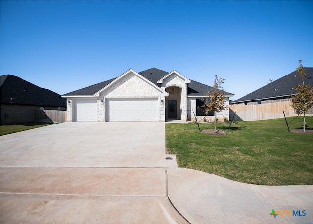 view of front of property with a front lawn and a garage