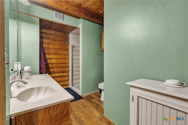2662 Edgegrove, Canyon Lake, TX 78133 - bathroom featuring rustic walls, wooden ceiling, a shower stall, wood finished floors, and double vanity