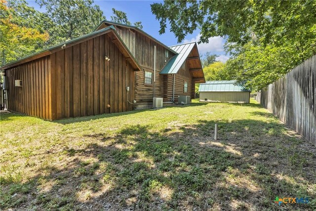 2662 Edgegrove, Canyon Lake, TX 78133 - back of house featuring board and batten siding, log siding, a metal roof, and a standing seam roof