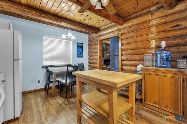 2662 Edgegrove, Canyon Lake, TX 78133 - dining space with a wooden ceiling with exposed beams, log walls, a ceiling fan, light wood-style floors, and a chandelier
