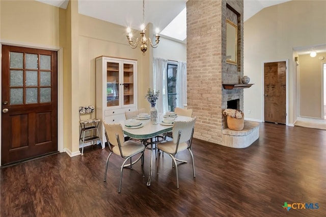 112 Laramie Dr, Victoria, TX 77904 - dining room with high vaulted ceiling, wood finished floors, a chandelier, and a fireplace