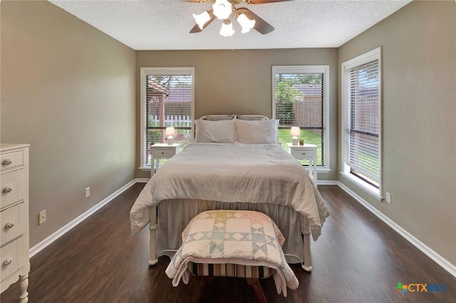 112 Laramie Dr, Victoria, TX 77904 - bedroom with dark wood-style floors, a textured ceiling, and ceiling fan
