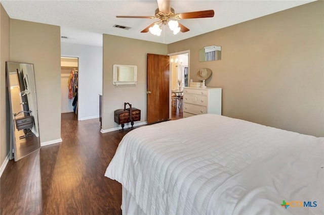 112 Laramie Dr, Victoria, TX 77904 - bedroom with wood finished floors, a walk in closet, a closet, and ceiling fan