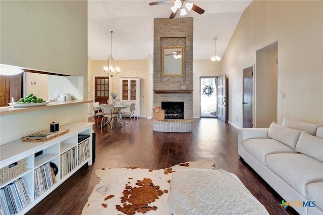 112 Laramie Dr, Victoria, TX 77904 - living room featuring a ceiling fan, high vaulted ceiling, wood finished floors, a chandelier, and a brick fireplace