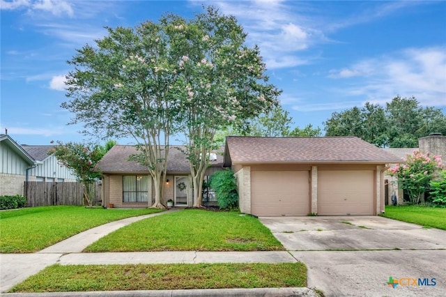 112 Laramie Dr, Victoria, TX 77904 - view of front of house with an attached garage, concrete driveway, and brick siding