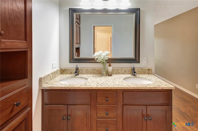 112 Laramie Dr, Victoria, TX 77904 - full bathroom featuring double vanity and wood finished floors
