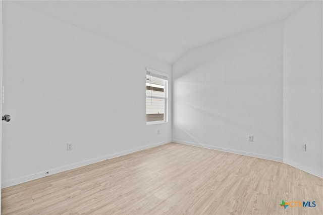9063 Rancher Trl, Seguin, TX 78155 - empty room featuring vaulted ceiling, light wood-style flooring, and baseboards
