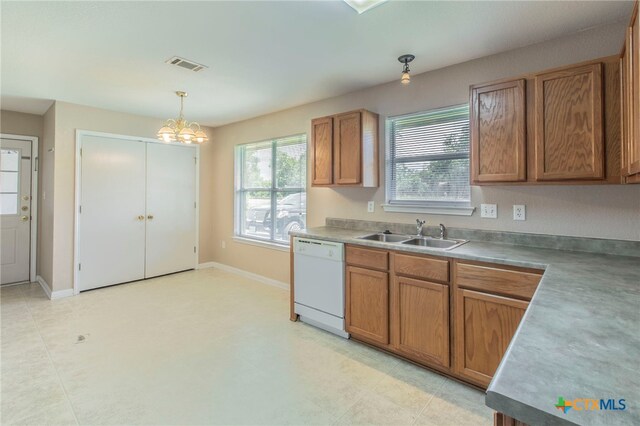 1012 N Beal St, Belton, TX 76513 - kitchen with dishwasher, brown cabinets, hanging light fixtures, and a chandelier