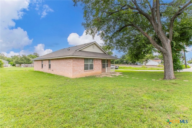1012 N Beal St, Belton, TX 76513 - view of side of home with brick siding and a lawn