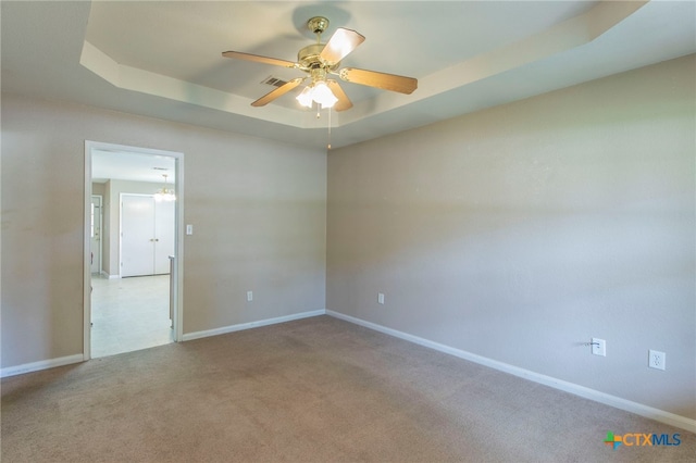 1012 N Beal St, Belton, TX 76513 - carpeted spare room featuring a tray ceiling and a ceiling fan