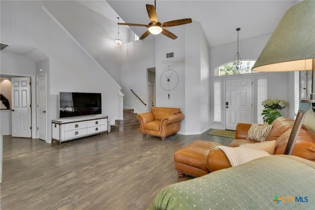 3405 Campanella Dr, Round Rock, TX 78665 - living area featuring high vaulted ceiling, stairs, wood finished floors, ceiling fan, and baseboards