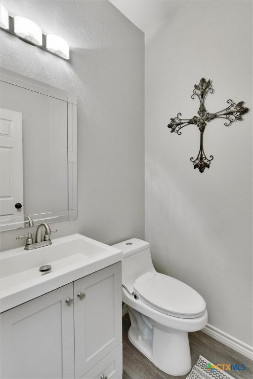 3405 Campanella Dr, Round Rock, TX 78665 - bathroom featuring wood finished floors, vanity, toilet, and baseboards