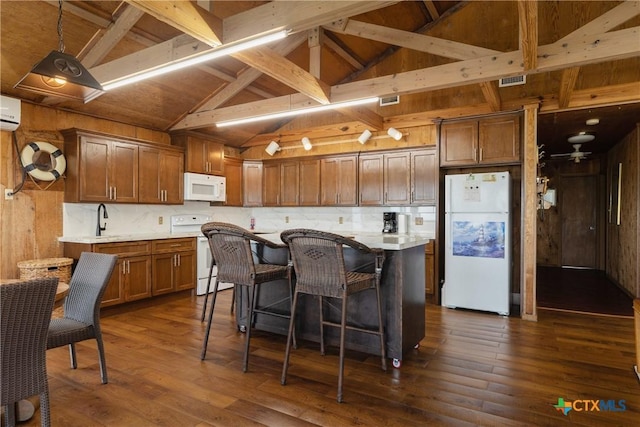 616 N Shore Dr, Port Mansfield, TX 78598 - kitchen with white appliances, dark wood-style flooring, decorative backsplash, a breakfast bar area, and beam ceiling