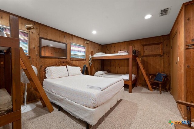 616 N Shore Dr, Port Mansfield, TX 78598 - bedroom featuring wood walls, light carpet, multiple windows, and recessed lighting