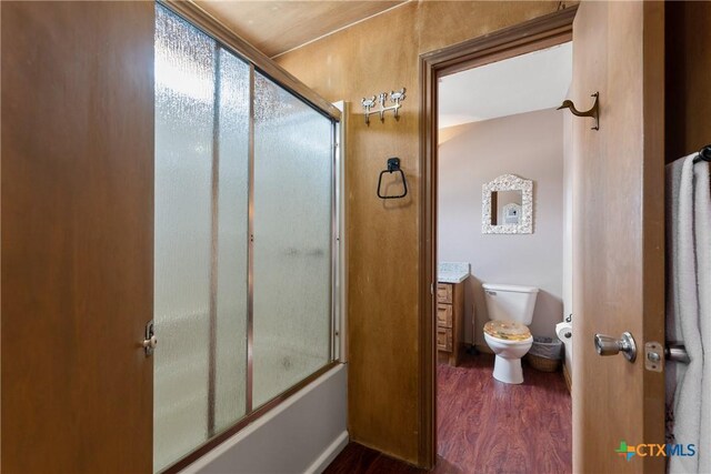 616 N Shore Dr, Port Mansfield, TX 78598 - full bath featuring wood finished floors, toilet, and bath / shower combo with glass door