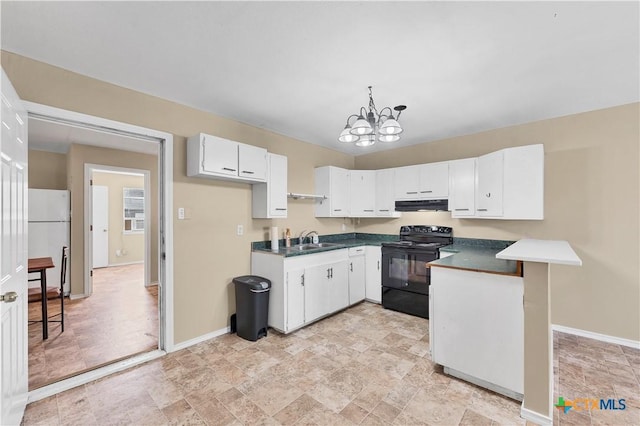 kitchen featuring ventilation hood, black range with electric stovetop, a peninsula, freestanding refrigerator, and a sink