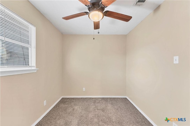 unfurnished room featuring a ceiling fan, visible vents, carpet, and baseboards