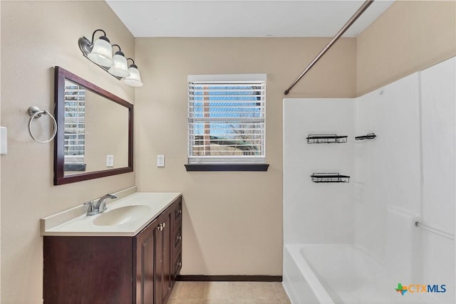 full bathroom with vanity, bathtub / shower combination, and baseboards