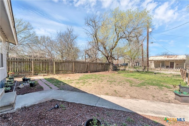 view of yard with a garden and a fenced backyard