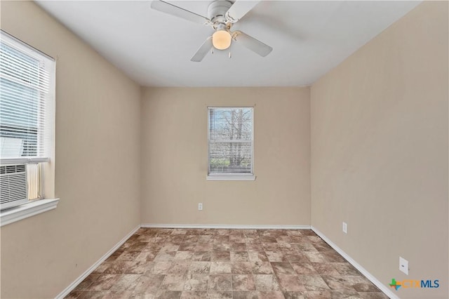 empty room with plenty of natural light, baseboards, and ceiling fan