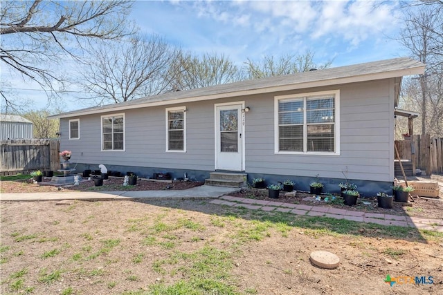 single story home with entry steps and fence