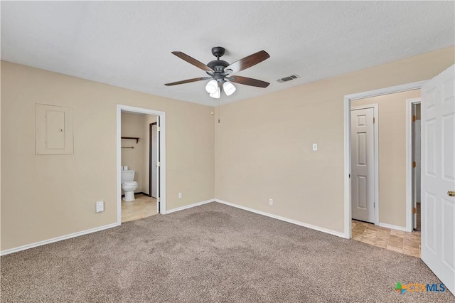 unfurnished bedroom with visible vents, baseboards, carpet floors, electric panel, and a textured ceiling