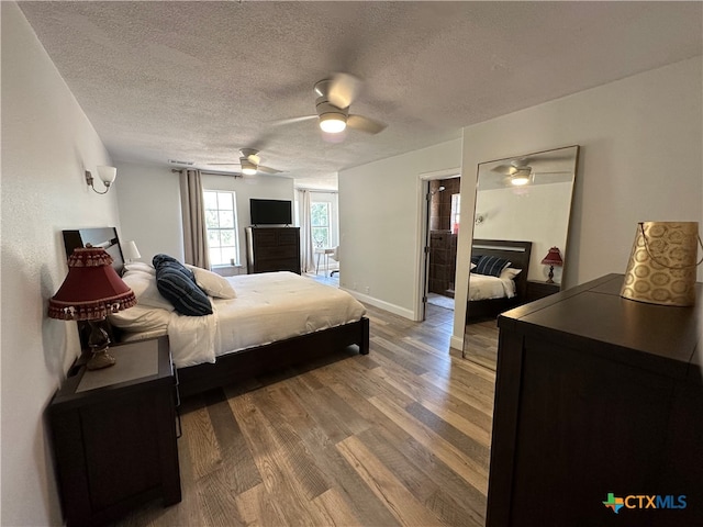 bedroom featuring ceiling fan, a textured ceiling, and hardwood / wood-style flooring