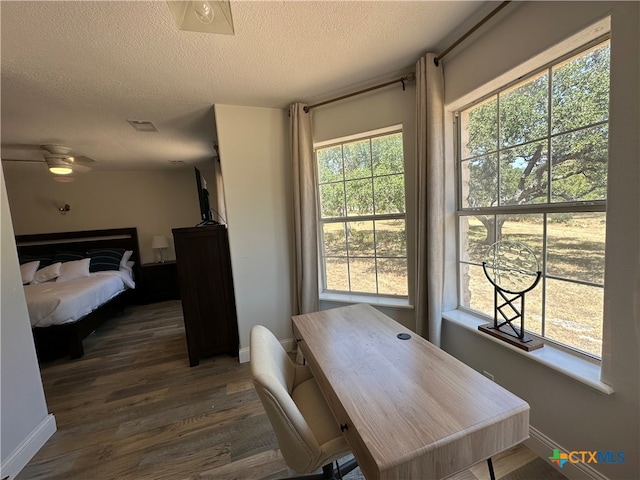 dining area with dark hardwood / wood-style floors, ceiling fan, and a textured ceiling