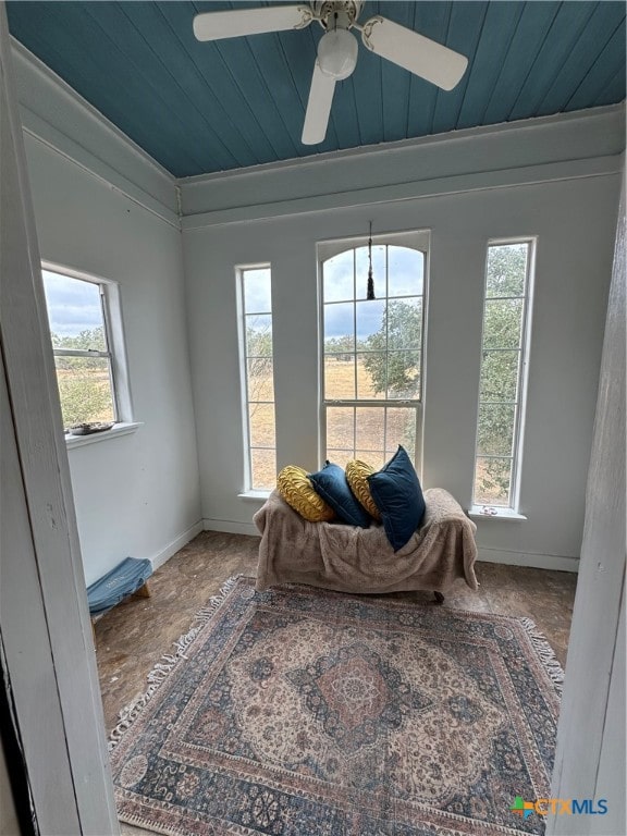 sitting room with a wealth of natural light, wooden ceiling, and ornamental molding