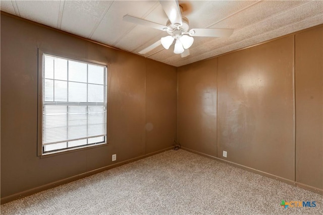 empty room featuring carpet and ceiling fan