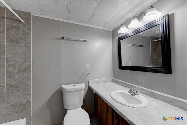 bathroom featuring vanity, toilet, and a textured ceiling