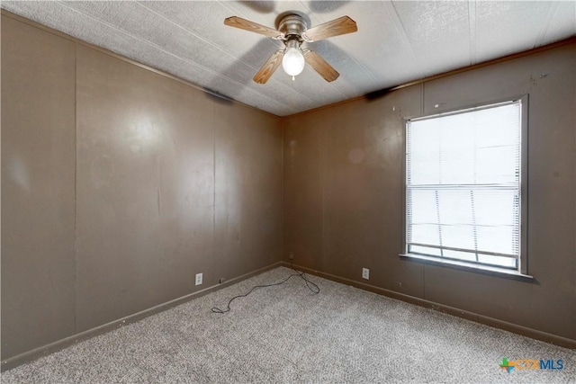 unfurnished room with ceiling fan, carpet floors, and a textured ceiling