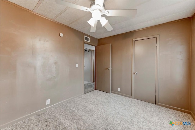 unfurnished bedroom featuring carpet, a closet, and ceiling fan