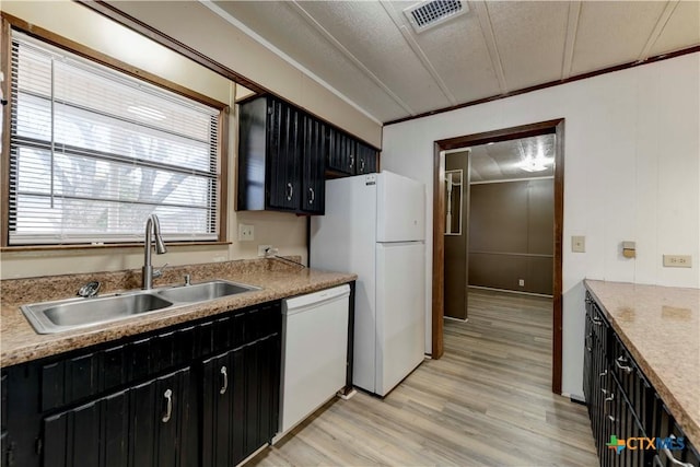 kitchen featuring sink, light hardwood / wood-style flooring, crown molding, a textured ceiling, and white appliances