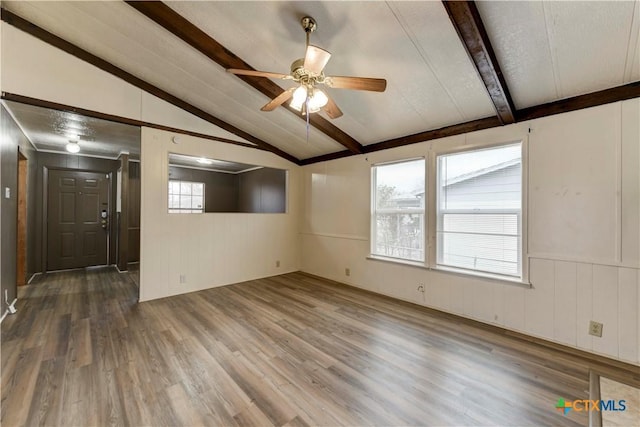 unfurnished room featuring lofted ceiling with beams, dark hardwood / wood-style floors, and ceiling fan