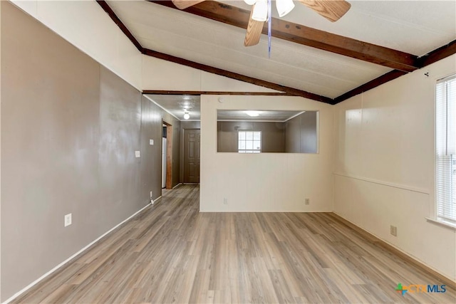 basement with a wealth of natural light, ceiling fan, and hardwood / wood-style flooring